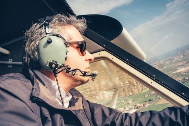 Male amateur pilot flying light aircraft Male amateur pilot flying light aircraft