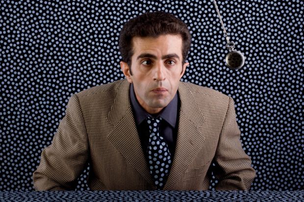 Man being hypnotised by swinging pendulum