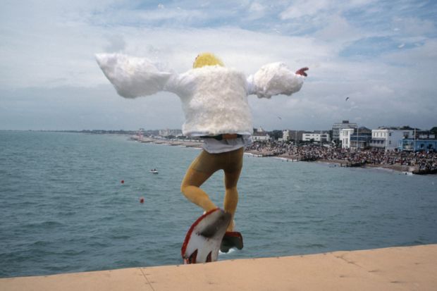 Man dressed as bird jumping into sea, Bognor Regis, England Man dressed as bird jumping into sea, Bognor Regis, England