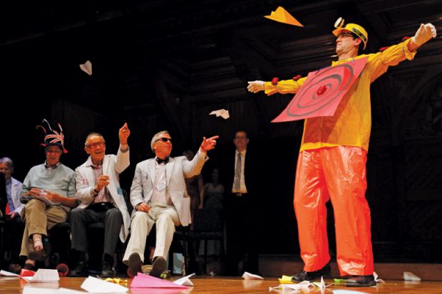 Man dressed as target hit by thrown paper aeroplanes Man dressed as target hit by thrown paper aeroplanes