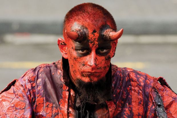 Man dressed as the devil/satan Man dressed as the devil/satan