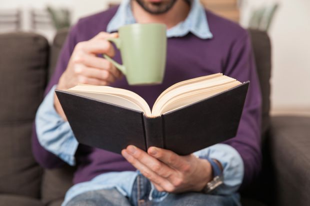 Man drinking coffee and reading book Man drinking coffee and reading book