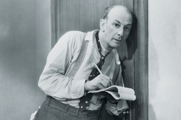 Man eavesdropping and taking notes at door Man eavesdropping and taking notes at door