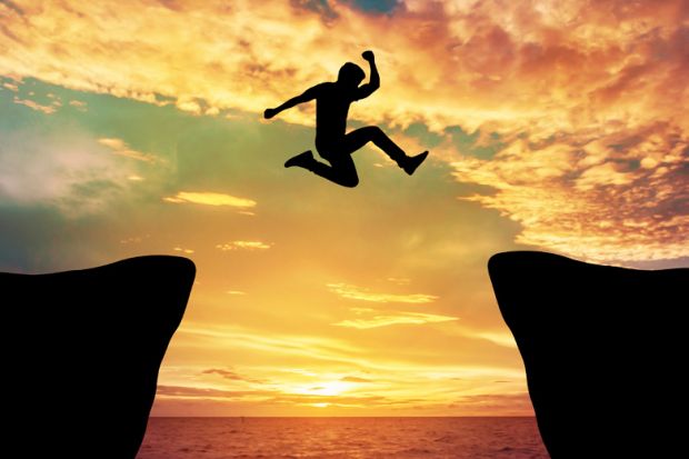 Man jumping between rocks against sunset Man jumping between rocks against sunset