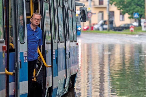 Man on tram stuck on flooded street, Wroclaw, Poland Man on tram stuck on flooded street, Wroclaw, Poland
