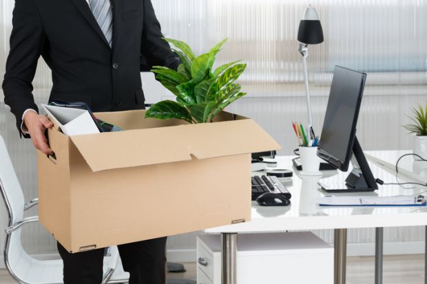 Man clearing desk