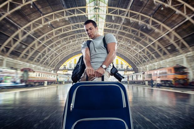Man dragging heavy luggage