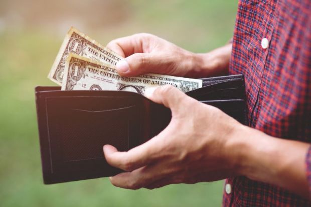 Man getting dollar notes out of wallet Man getting dollar notes out of wallet