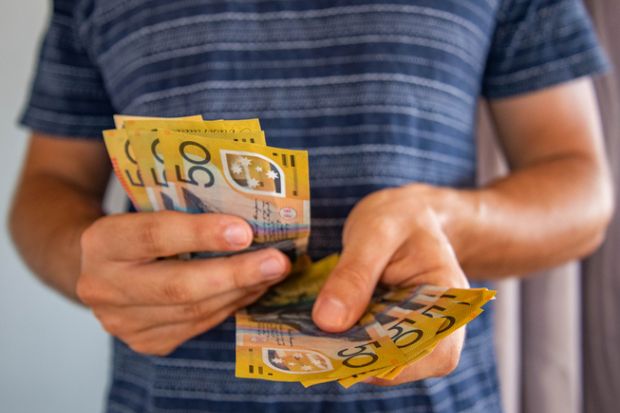 Man handling fifty dollar notes