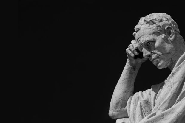 Man statue in the act of thinking against blue sky. Ancient Roman Julian the Jurist statue made at the end of 19th century in front of the Old Palace of Justice in Rome
