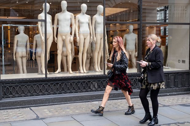 People passing a shop window filled with mannequins in the empty interior of a fashion retailer, London. To illustrate that without oversight of university mergers, the UK risks “sleepwalking” into a homogenised higher education sector. People passing a shop window filled with mannequins in the empty interior of a fashion retailer, London. To illustrate that without oversight of university mergers, the UK risks “sleepwalking” into a homogenised higher education sector.