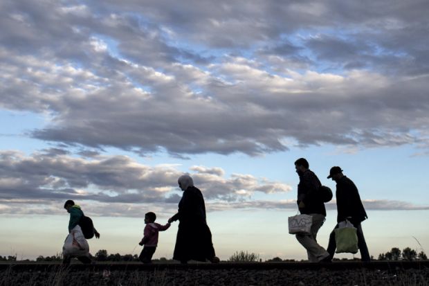 Migrants walk along rail tracks, Roszke, Hungary, 2015 Migrants walk along rail tracks, Roszke, Hungary, 2015