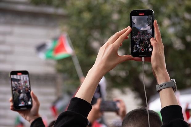 Protesters using phones to film a protest about the Israel-Gaza conflict. To illustrate students being fearful after the Trump administration’s proposal to vet all international students’ social media. Protesters using phones to film a protest about the Israel-Gaza conflict. To illustrate students being fearful after the Trump administration’s proposal to vet all international students’ social media.