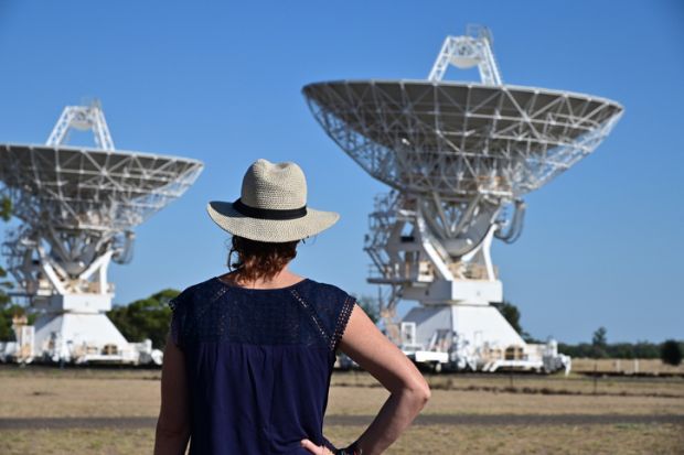 Narrabri, Nsw- MAR 03 2023Australian woman looking at the Telescope Compact Array near Narrabri NSW, that observe star formation, the late stages of stars lives, supernovae and magnetic fields.