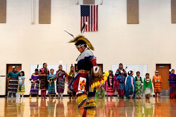 A student performs a traditional style dance in full regalia at the 21st Century Community Learning Center, USA. Students that are part of the after school learning program learn the Arapaho language, culture, history and traditions of the Arapaho tribe.