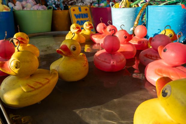 Newcastle upon Tyne, United Kingdom – June 21, 2023 Floating toy ducks at the Hook-a-duck sideshow stall at the funfair. Newcastle upon Tyne, United Kingdom – June 21, 2023 Floating toy ducks at the Hook-a-duck sideshow stall at the funfair.