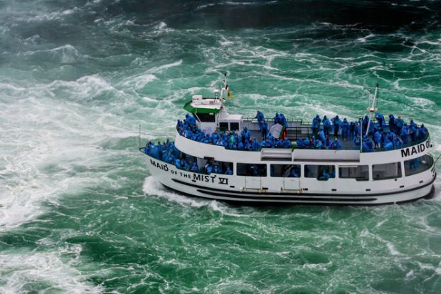 Niagara Falls, NY, USA - June 13, 2019 Ship with tourists moves to Niagara falls, Falls boat tour experience is North America oldest attraction, and has drawn millions of visitors since 1846 Niagara Falls, NY, USA - June 13, 2019 Ship with tourists moves to Niagara falls, Falls boat tour experience is North America oldest attraction, and has drawn millions of visitors since 1846