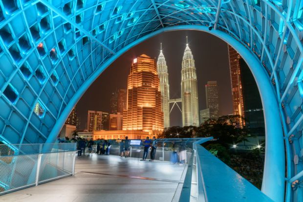 Night view of the Petronas Twin Towers through Saloma Link Bridge. Awesome Kuala Lumpur skyline Night view of the Petronas Twin Towers through Saloma Link Bridge. Awesome Kuala Lumpur skyline