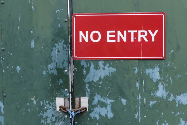 A no entry sign on a locked door A no entry sign on a locked door illustrating visa application issues, UK Home Office, academic spouse visa