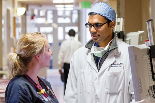 Nurse speaks with doctor. Stanford University Hospital and Clinics Nurse speaks with doctor. Stanford University Hospital and Clinics