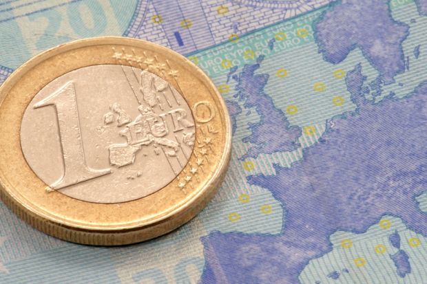 One Euro coin placed on map of Europe One Euro coin placed on map of Europe