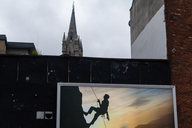Optical illusion, image of a man climbing to the top of Catholic cathedral Optical illusion, image of a man climbing to the top of Catholic cathedral