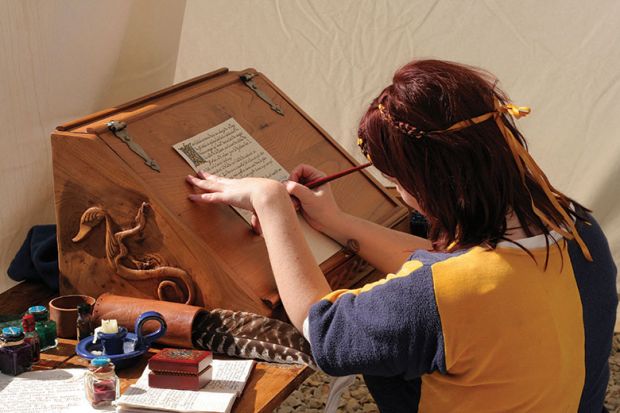 Woman writing dressed in medieval clothes
