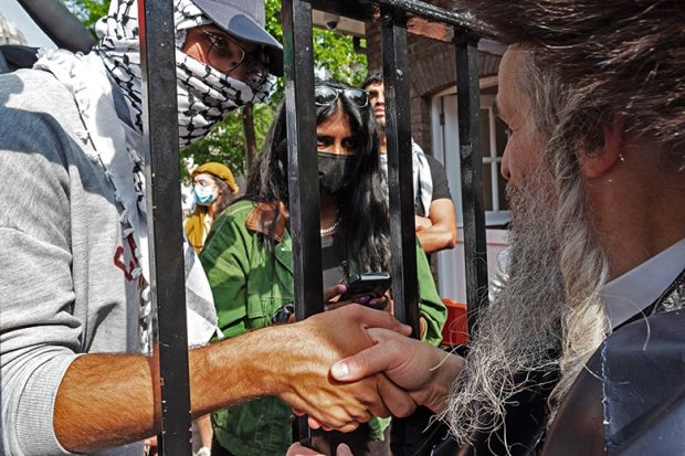Jewish man shaking hands with Palestine supporters as they protest against Israel’s war on Gaza in the grounds of UCL, 11 May 2024. To illustrate an ability to foster both free speech and civil disagreement.