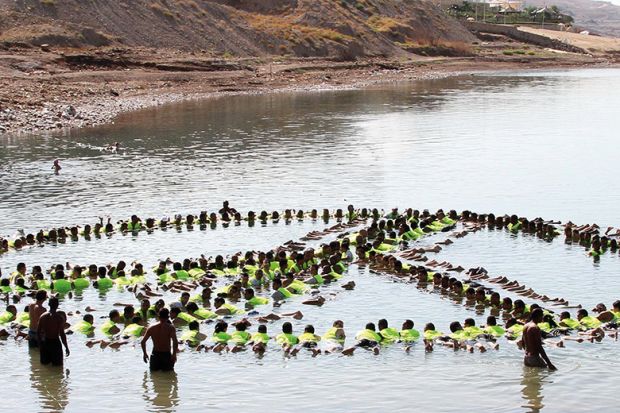 people make the shape of a peace sign in the water people make the shape of a peace sign in the water