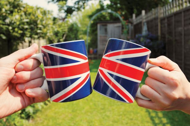 People holding Union Jack flag tea cups People holding Union Jack flag tea cups
