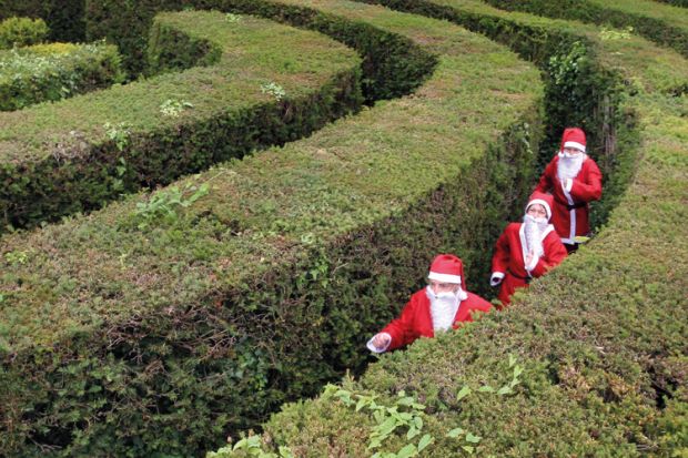 People in maze dressed as Santa Claus People in maze dressed as Santa Claus