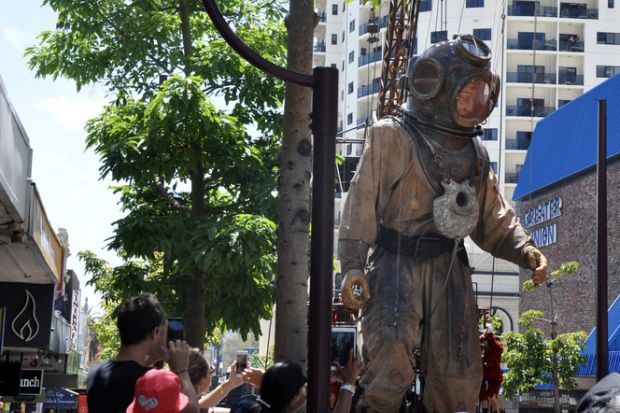 Perth,WA,Australia-February 14,2015 Giant marionette diver and spectators at the Perth International Arts Festival, Journey of the Giants, in Western Australia. Perth,WA,Australia-February 14,2015 Giant marionette diver and spectators at the Perth International Arts Festival, Journey of the Giants, in Western Australia.