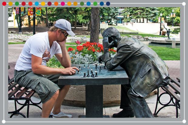 Person playing chess against a statue, illustrating the need to value technical knowledge and soft skills Person playing chess against a statue, illustrating the need to value technical knowledge and soft skills