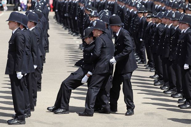 A police officer is caught by colleagues as he becomes faint during a Passing out Parade for the Metropolitan Police. To illustrate how the assessment burden is causing students to wilt A police officer is caught by colleagues as he becomes faint during a Passing out Parade for the Metropolitan Police. To illustrate how the assessment burden is causing students to wilt
