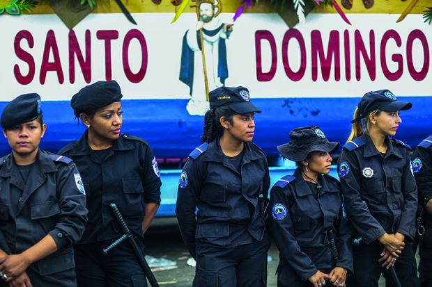 A number of female Nicaraguan police stand in a row A number of female Nicaraguan police stand in a row
