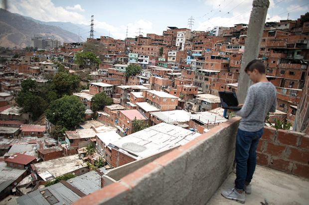 Boy with laptop on balcony Boy with laptop on balcony