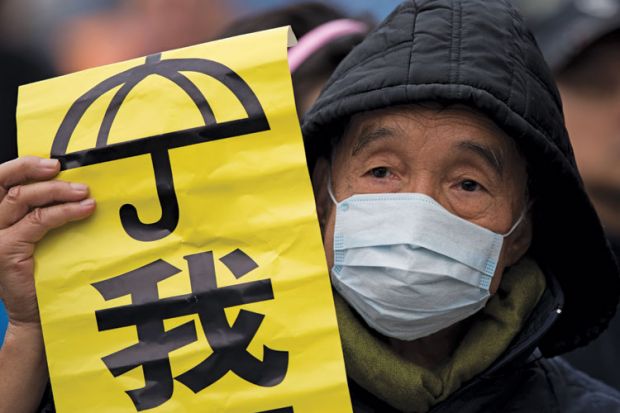 Protestor holding banner, Admiralty District, Hong Kong Protestor holding banner, Admiralty District, Hong Kong
