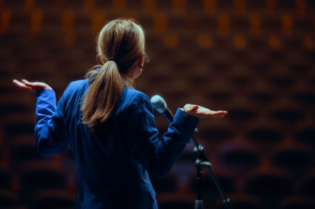 A public speaker shrugs A public speaker shrugs