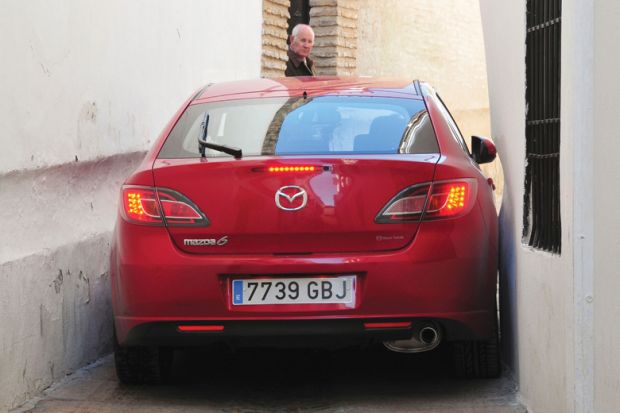 Red car stuck in alleyway, Córdoba, Spain Red car stuck in alleyway, Córdoba, Spain