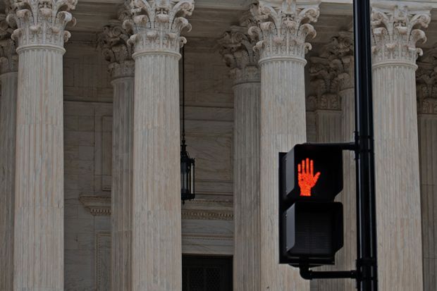 Red hand stop sign in from of classical columns to illustrate that serious abuses should stop being investigated only by universities. Red hand stop sign in from of classical columns to illustrate that serious abuses should stop being investigated only by universities.