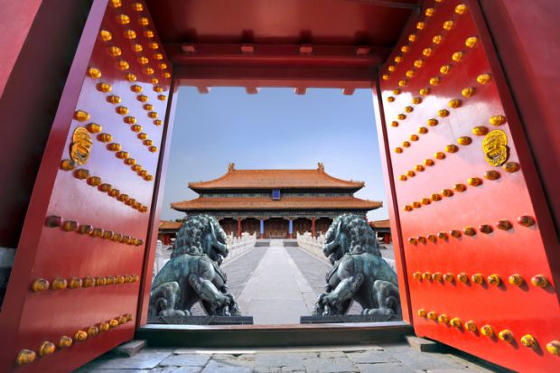 Red entrance gate opening to the forbidden city in Beijing - China