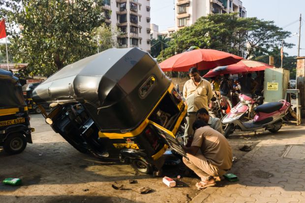A rickshaw wheel is repaired A rickshaw wheel is repaired