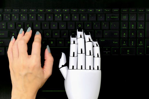 A robot and human hand on a computer keyboard, symbolising AI-assisted writing A robot and human hand on a computer keyboard, symbolising AI-assisted writing
