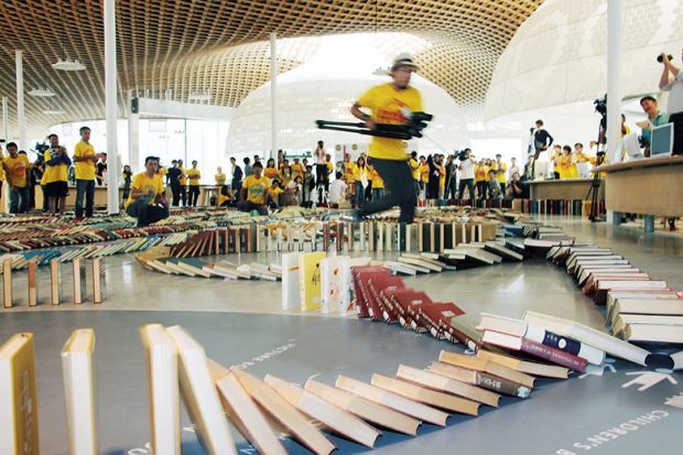 Running with camera to capture book domino chain Running with camera to capture book domino chain