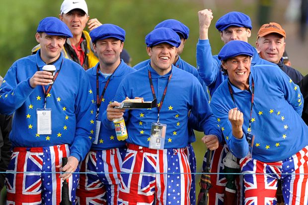 Golf fans wearing flags of the UK, EU and USA at the Ryder Cup golf competition between US and Europe. To illustrate that the UK and Europe should woo disaffected American scientists. Golf fans wearing flags of the UK, EU and USA at the Ryder Cup golf competition between US and Europe. To illustrate that the UK and Europe should woo disaffected American scientists.