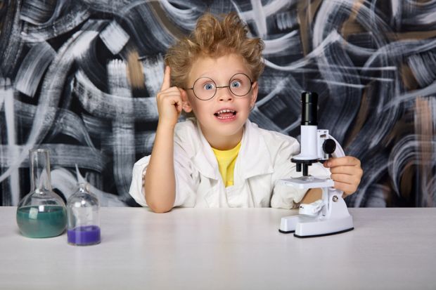 A young boy does a science experiment A young boy does a science experiment