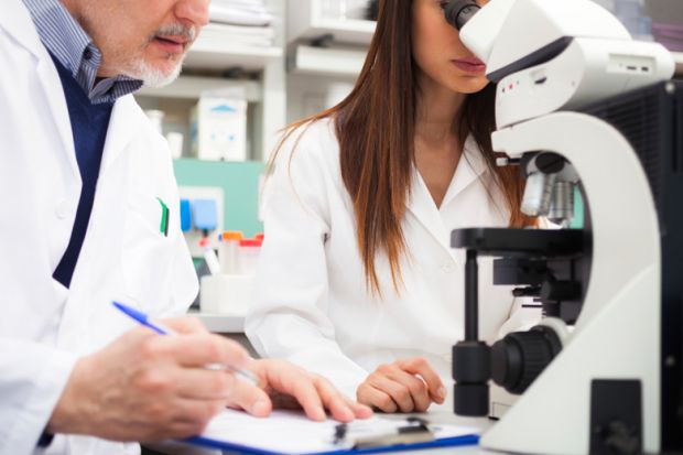 Scientists collaborating in laboratory Scientists collaborating in laboratory