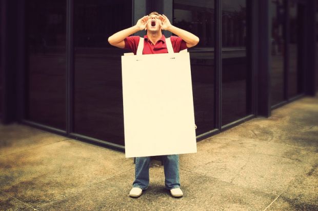 Screaming man wearing sandwich board in street Screaming man wearing sandwich board in street