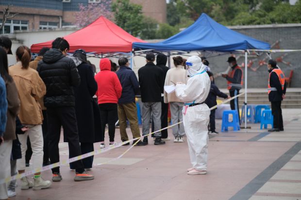 Shanghai,China-March 19th 2022 many Chinese people line up to receive nucleic acid test for Covid-19 coronavirus at local community. Shanghai is seeing a resurgence of covid-19 Omicron
