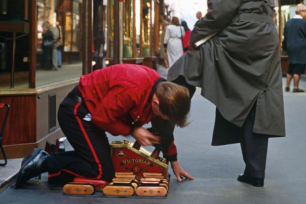 Shoeshine boy polishing man's shoes Shoeshine boy polishing man's shoes
